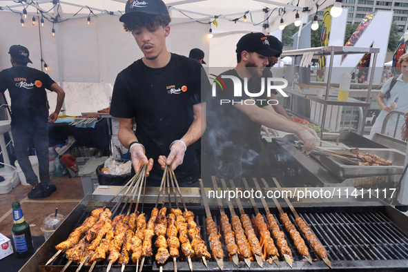 A man is grilling Syrian Aleppo-style kabobs during the Taste of the Middle East Food Festival in Toronto, Ontario, Canada, on July 06, 2024...