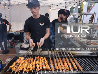 A man is grilling Syrian Aleppo-style kabobs during the Taste of the Middle East Food Festival in Toronto, Ontario, Canada, on July 06, 2024...