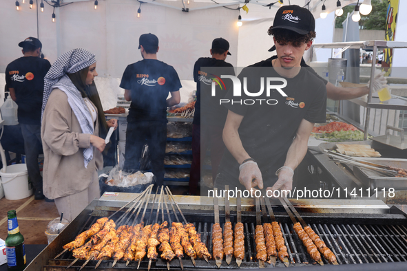 A man is grilling Syrian Aleppo-style kabobs during the Taste of the Middle East Food Festival in Toronto, Ontario, Canada, on July 06, 2024...