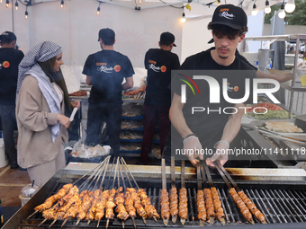 A man is grilling Syrian Aleppo-style kabobs during the Taste of the Middle East Food Festival in Toronto, Ontario, Canada, on July 06, 2024...