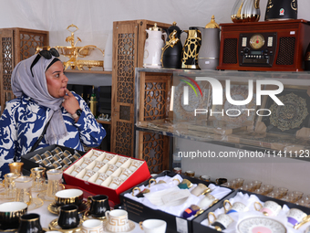 A woman is looking at various Islamic items from Dubai during the Taste of the Middle East Food Festival in Toronto, Ontario, Canada, on Jul...