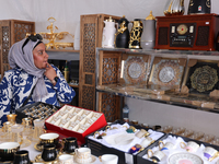 A woman is looking at various Islamic items from Dubai during the Taste of the Middle East Food Festival in Toronto, Ontario, Canada, on Jul...