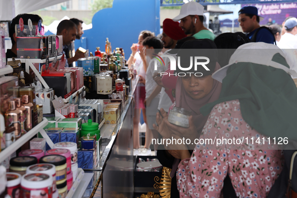 A woman is looking at beauty products from Dubai during the Taste of the Middle East Food Festival in Toronto, Ontario, Canada, on July 06,...