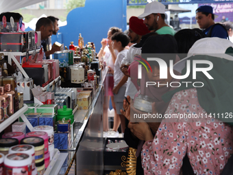 A woman is looking at beauty products from Dubai during the Taste of the Middle East Food Festival in Toronto, Ontario, Canada, on July 06,...