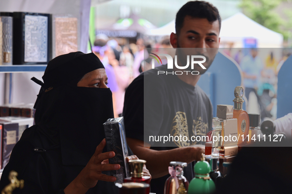 A woman is looking at perfume from Dubai during the Taste of the Middle East Food Festival in Toronto, Ontario, Canada, on July 06, 2024. Th...