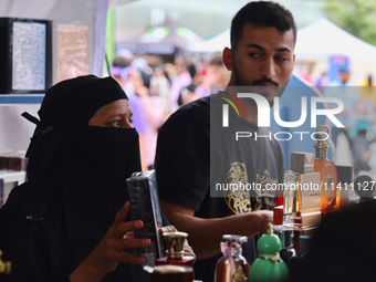 A woman is looking at perfume from Dubai during the Taste of the Middle East Food Festival in Toronto, Ontario, Canada, on July 06, 2024. Th...