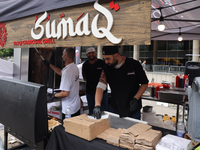 Men are preparing food at the Iraqi charcoal grill during the Taste of the Middle East Food Festival in Toronto, Ontario, Canada, on July 06...