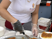 A woman is serving Kunafa in Toronto, Ontario, Canada, on June 06, 2024. Kunafa (knafeh) is a traditional Arabic dessert, made with spun pas...