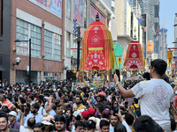 Thousands of Hindu devotees are taking part in the chariot procession as they escort the chariots carrying the deities during the annual Rat...