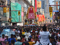 Thousands of Hindu devotees are taking part in the chariot procession as they escort the chariots carrying the deities during the annual Rat...