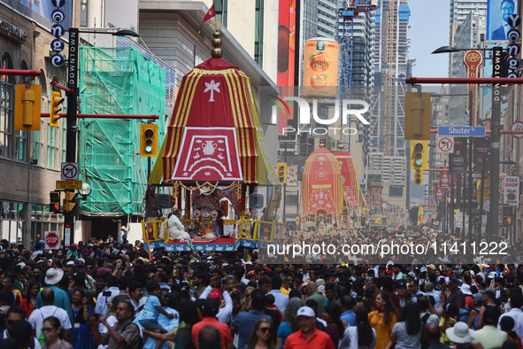 Thousands of Hindu devotees are taking part in the chariot procession as they escort the chariots carrying the deities during the annual Rat...