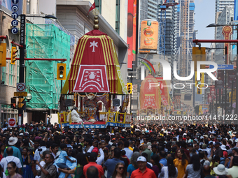 Thousands of Hindu devotees are taking part in the chariot procession as they escort the chariots carrying the deities during the annual Rat...