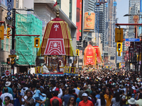 Thousands of Hindu devotees are taking part in the chariot procession as they escort the chariots carrying the deities during the annual Rat...