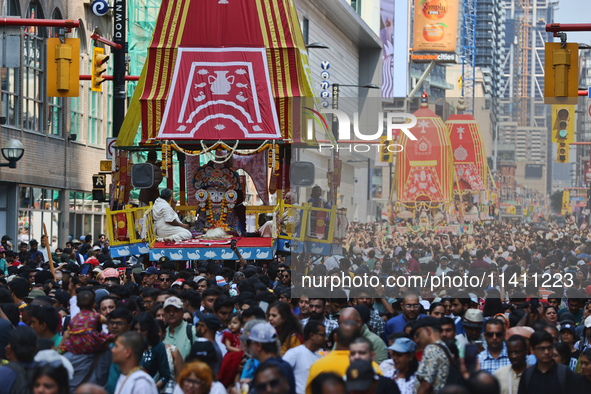 Thousands of Hindu devotees are taking part in the chariot procession as they escort the chariots carrying the deities during the annual Rat...