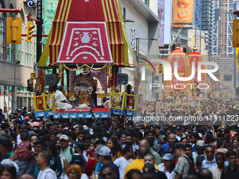 Thousands of Hindu devotees are taking part in the chariot procession as they escort the chariots carrying the deities during the annual Rat...