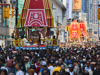 Thousands of Hindu devotees are taking part in the chariot procession as they escort the chariots carrying the deities during the annual Rat...