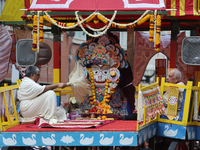 Hindu priests are performing prayers while traveling in the chariots carrying the deities during the annual Rath Yatra festival in Toronto,...