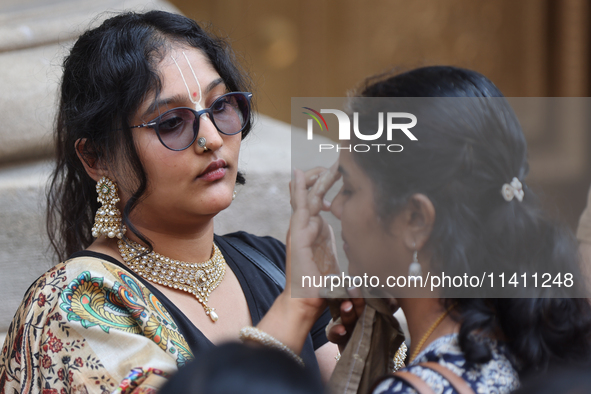 Tikkas are being applied to the foreheads of devotees as thousands of Hindu devotees are taking part in the procession during the annual Rat...