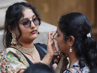 Tikkas are being applied to the foreheads of devotees as thousands of Hindu devotees are taking part in the procession during the annual Rat...