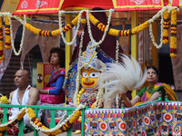 Hindu priests are performing prayers while traveling in the chariots carrying the deities during the annual Rath Yatra festival in Toronto,...