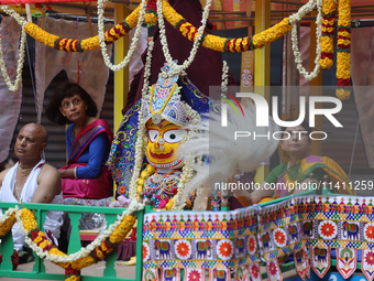 Hindu priests are performing prayers while traveling in the chariots carrying the deities during the annual Rath Yatra festival in Toronto,...