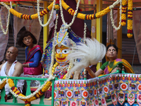 Hindu priests are performing prayers while traveling in the chariots carrying the deities during the annual Rath Yatra festival in Toronto,...