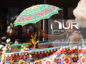 A Hindu priest is traveling in a chariot carrying the deities during the annual Rath Yatra festival in Toronto, Ontario, Canada, on July 13,...