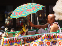 A Hindu priest is traveling in a chariot carrying the deities during the annual Rath Yatra festival in Toronto, Ontario, Canada, on July 13,...