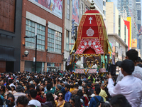 Thousands of Hindu devotees are taking part in the chariot procession as they escort the chariots carrying the deities during the annual Rat...