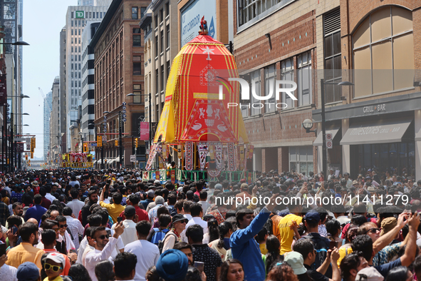 Thousands of Hindu devotees are taking part in the chariot procession as they escort the chariots carrying the deities during the annual Rat...