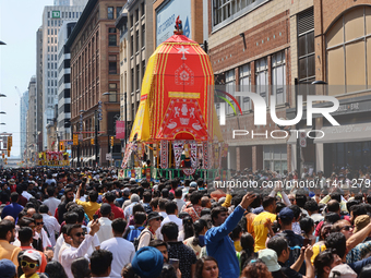 Thousands of Hindu devotees are taking part in the chariot procession as they escort the chariots carrying the deities during the annual Rat...