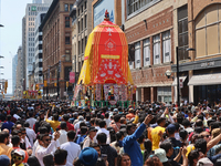 Thousands of Hindu devotees are taking part in the chariot procession as they escort the chariots carrying the deities during the annual Rat...