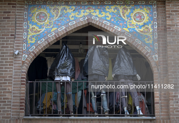 Mannequins are being covered with black plastic bags during a religious festival to commemorate Tasoua, a day ahead of Ashura, at a shop in...