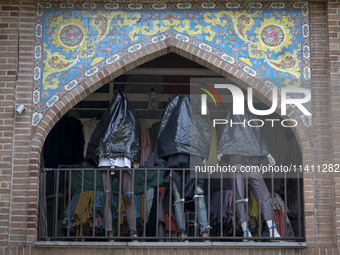 Mannequins are being covered with black plastic bags during a religious festival to commemorate Tasoua, a day ahead of Ashura, at a shop in...