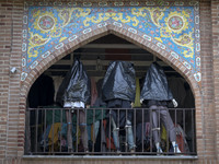 Mannequins are being covered with black plastic bags during a religious festival to commemorate Tasoua, a day ahead of Ashura, at a shop in...