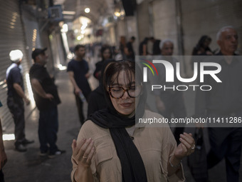 A young Iranian woman is praying while participating in a religious festival to commemorate Tasoua, a day ahead of Ashura, in the Grand Baza...