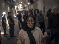 A young Iranian woman is praying while participating in a religious festival to commemorate Tasoua, a day ahead of Ashura, in the Grand Baza...