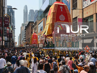 Thousands of Hindu devotees are taking part in the chariot procession as they escort the chariots carrying the deities during the annual Rat...