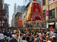 Thousands of Hindu devotees are taking part in the chariot procession as they escort the chariots carrying the deities during the annual Rat...