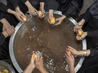 A group of Iranian women are preparing potatoes for use in donated meals during a religious festival to commemorate Tasoua, a day ahead of A...