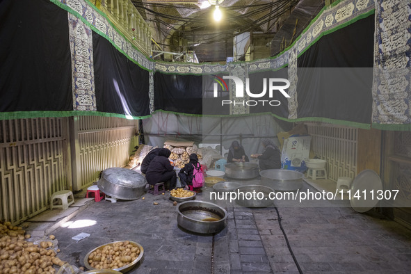 Iranian women are preparing potatoes for use in donated meals during a religious festival to commemorate Tasoua, a day ahead of Ashura, in t...