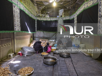 Iranian women are preparing potatoes for use in donated meals during a religious festival to commemorate Tasoua, a day ahead of Ashura, in t...