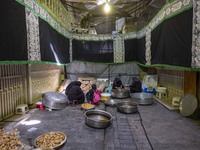 Iranian women are preparing potatoes for use in donated meals during a religious festival to commemorate Tasoua, a day ahead of Ashura, in t...