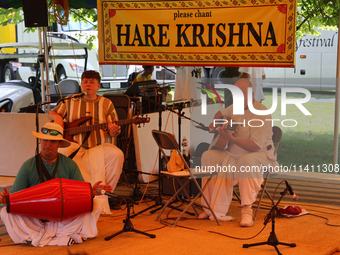 Hindu devotees are singing kirtans during the annual Rath Yatra festival in Toronto, Ontario, Canada, on July 13, 2024. The Rath Yatra festi...