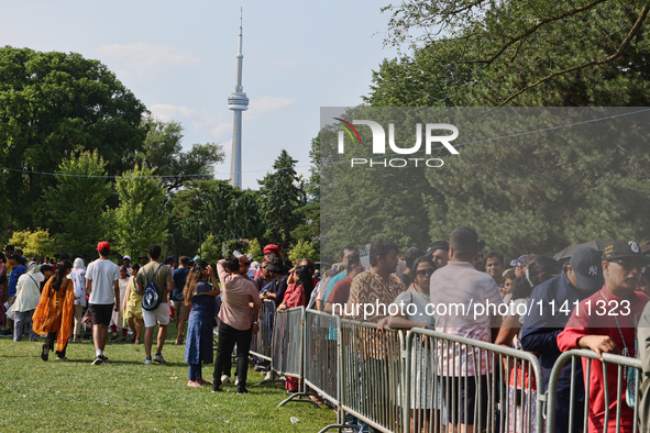 Thousands of Hindu devotees are waiting in line for free vegetarian food during the annual Rath Yatra festival in Toronto, Ontario, Canada,...