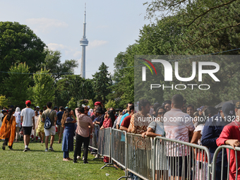 Thousands of Hindu devotees are waiting in line for free vegetarian food during the annual Rath Yatra festival in Toronto, Ontario, Canada,...