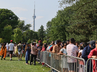 Thousands of Hindu devotees are waiting in line for free vegetarian food during the annual Rath Yatra festival in Toronto, Ontario, Canada,...