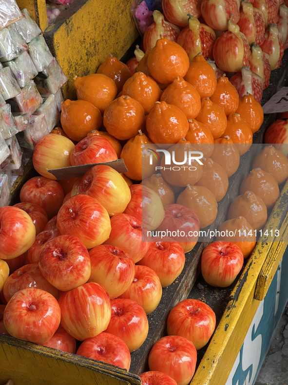 Fancy candles in the shape of fruit are being displayed at a small shop in Nainital, Uttarakhand, India, on April 21, 2024. 