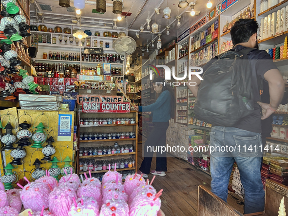 People are shopping for fancy candles at a small shop in Nainital, Uttarakhand, India, on April 21, 2024. 