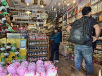 People are shopping for fancy candles at a small shop in Nainital, Uttarakhand, India, on April 21, 2024. (